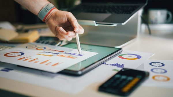 a person is writing on a piece of paper - IT Downtime 