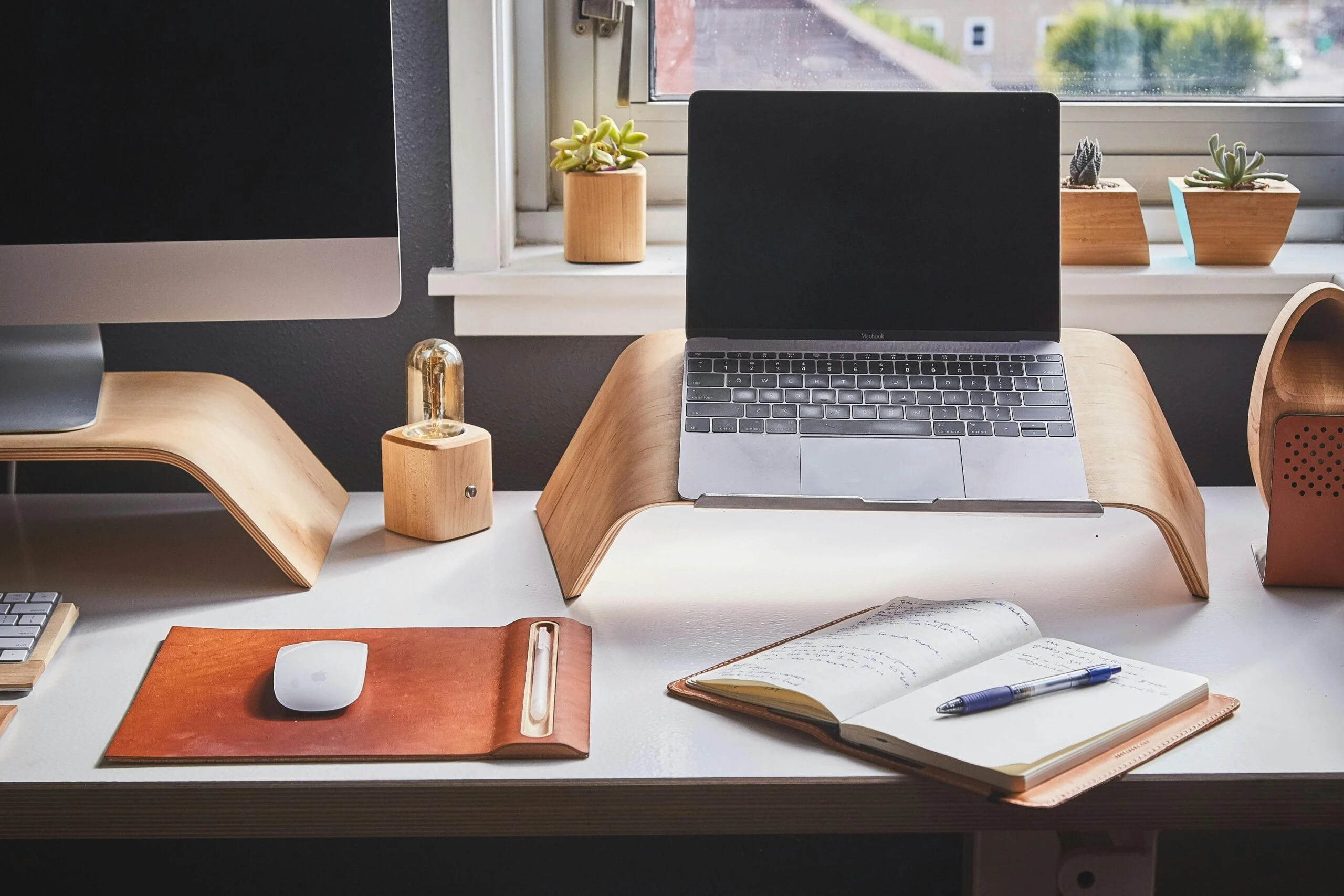 Device organization Free A stylish and contemporary home office setup with laptop and desk accessories. Stock Photo