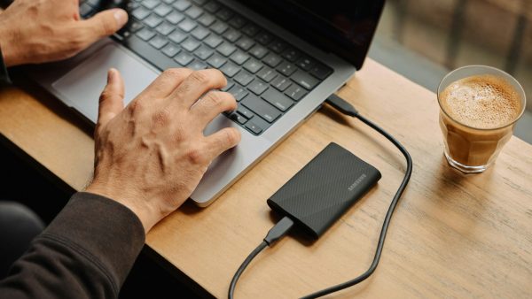 secure file storage A man sitting at a table using a laptop computer