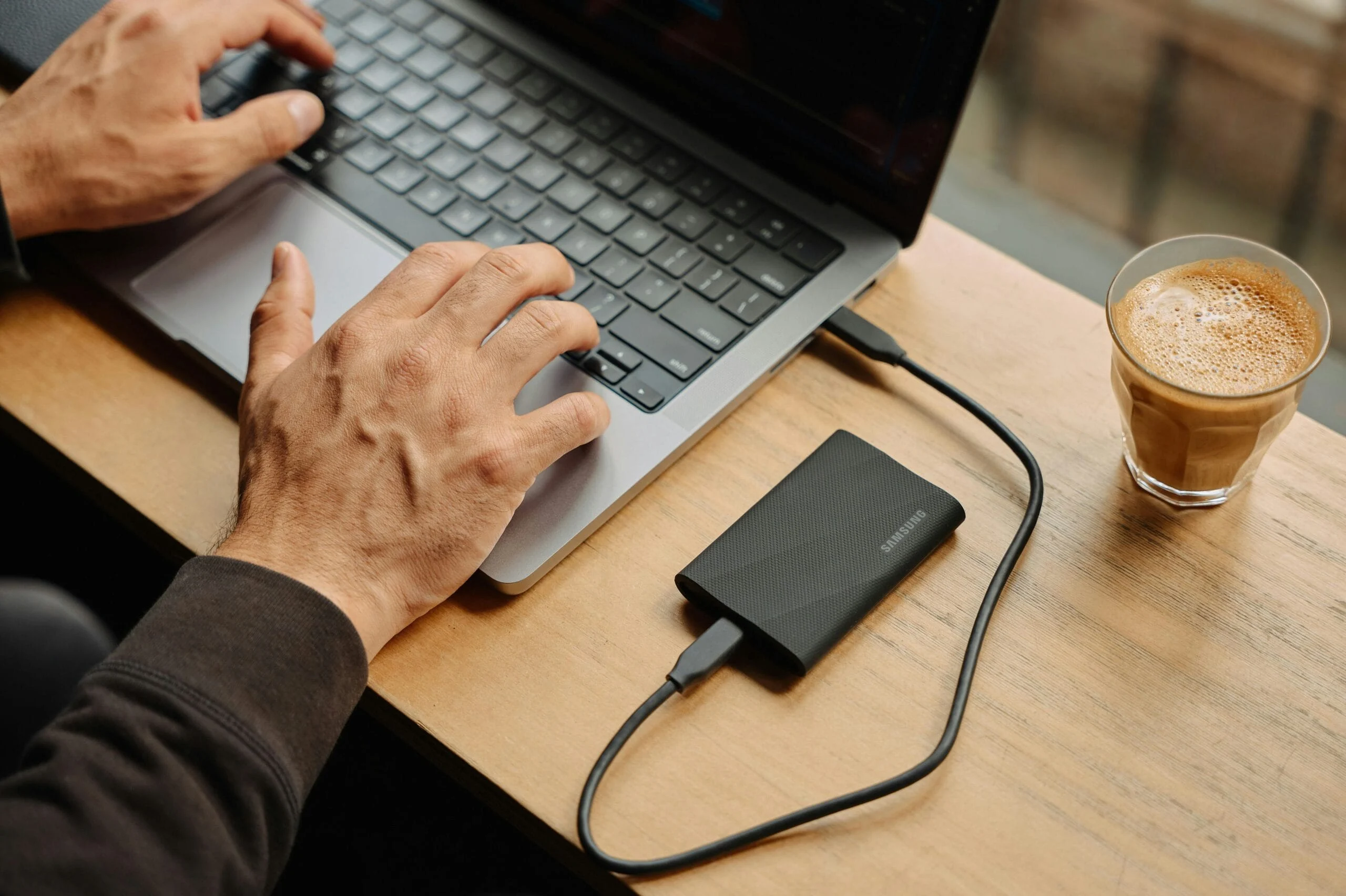 secure file storage A man sitting at a table using a laptop computer