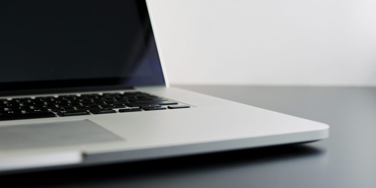 Buying used technology silver laptop computer on black table