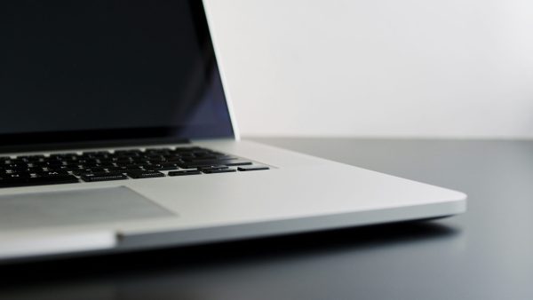 Buying used technology silver laptop computer on black table