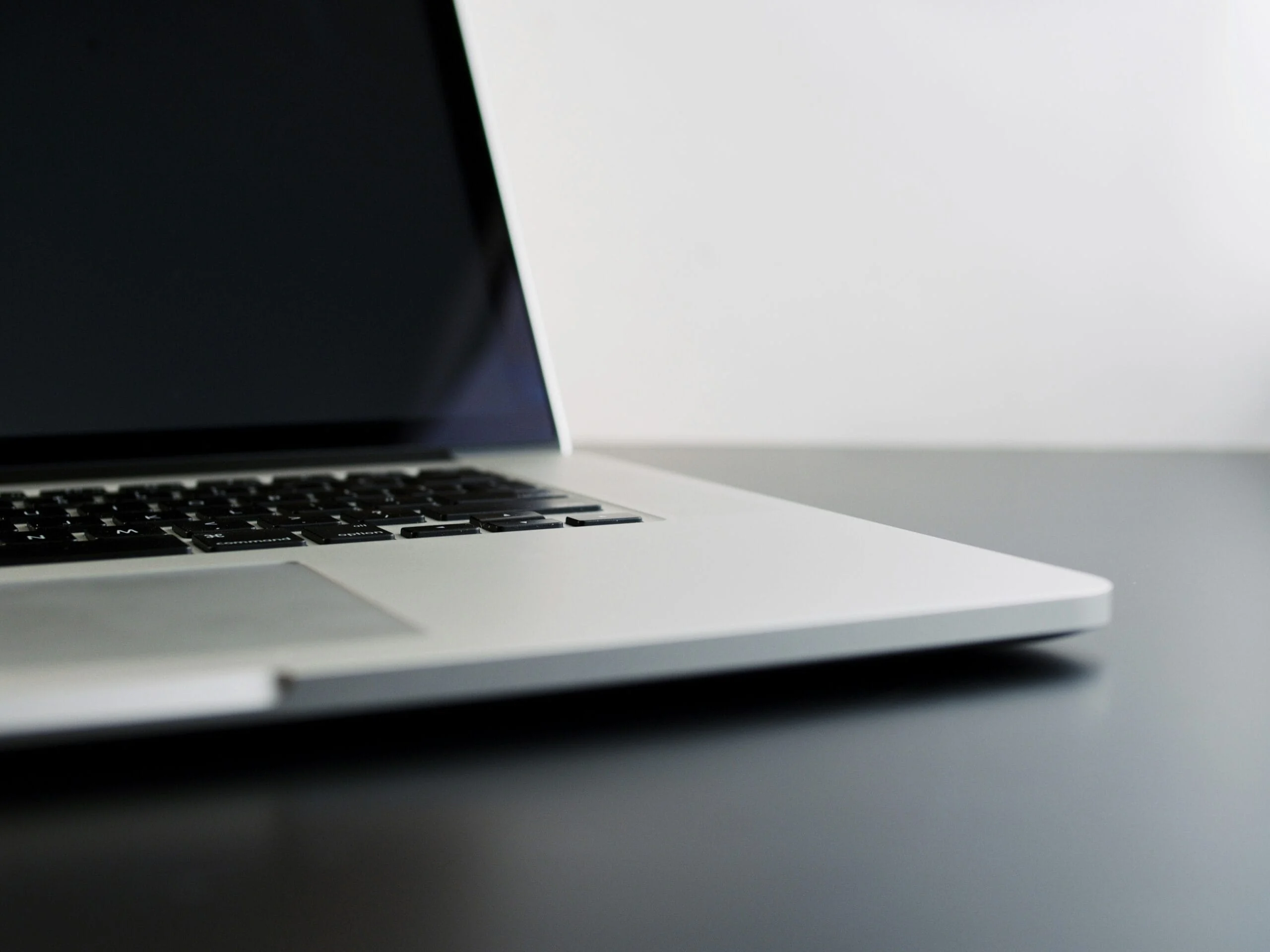 Buying used technology silver laptop computer on black table
