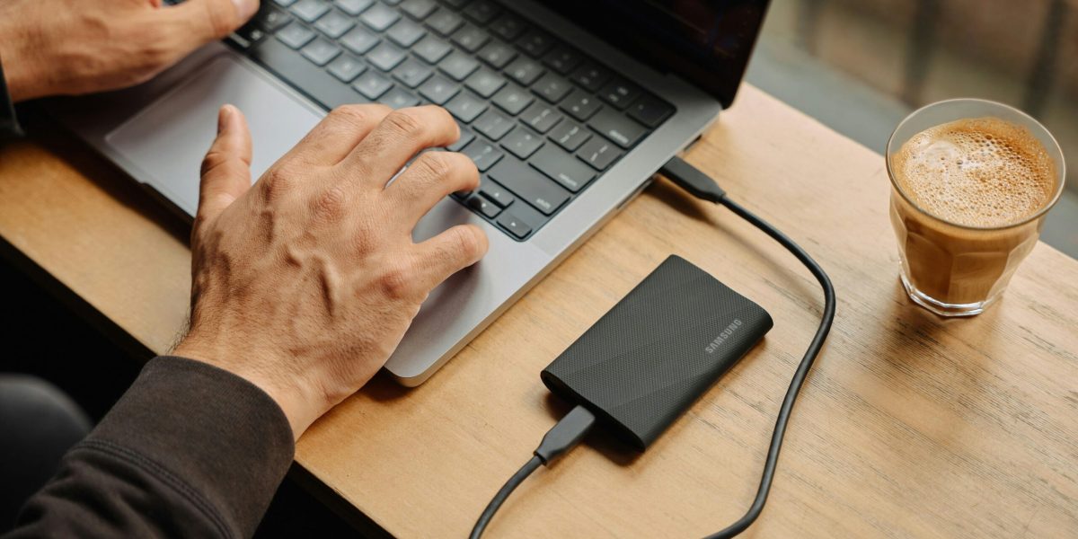 Device storage A man sitting at a table using a laptop computer