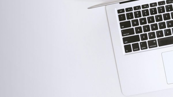 Device upgrade Free Aerial view of a sleek laptop keyboard on a clean, white surface, ideal for tech backgrounds. Stock Photo