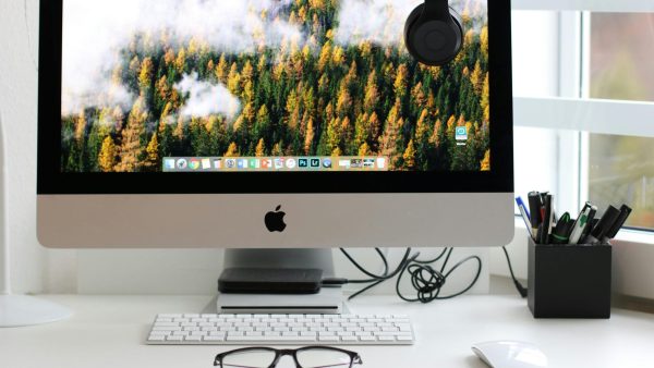 desktop customization Free Stylish home office workspace featuring a computer setup with accessories. Stock Photo