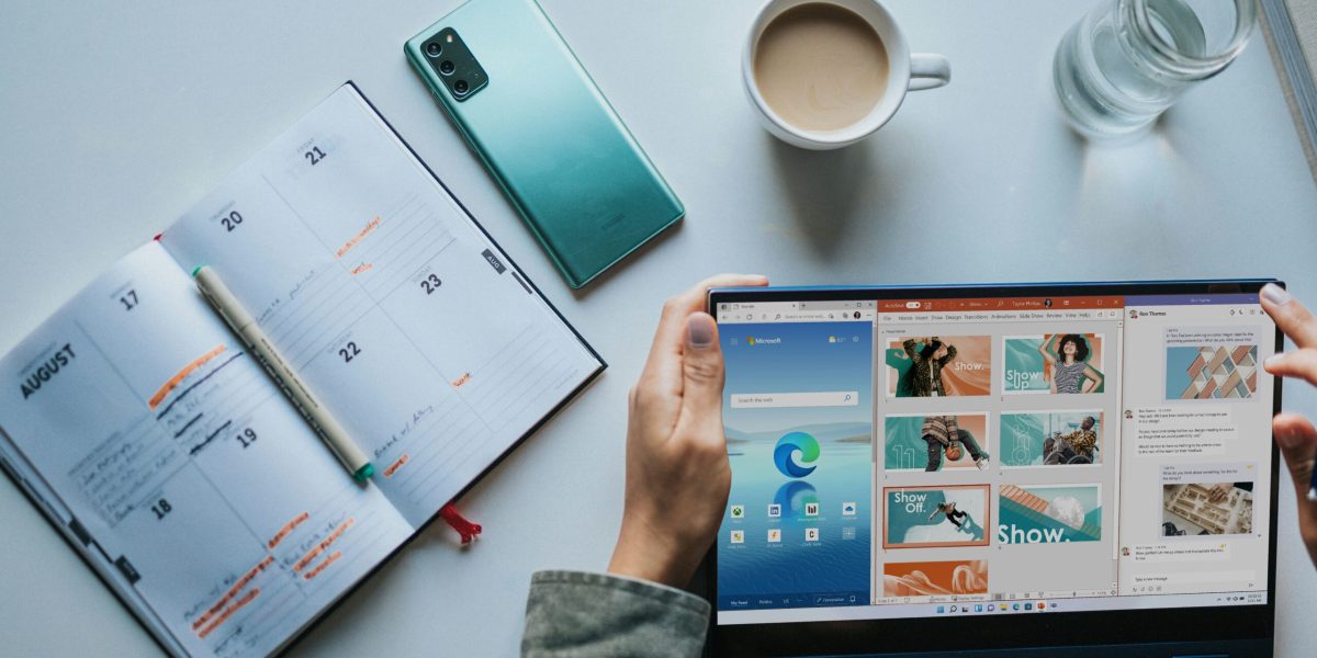 Microsoft 365 tips person using Windows 11 computer beside white ceramic mug on white table