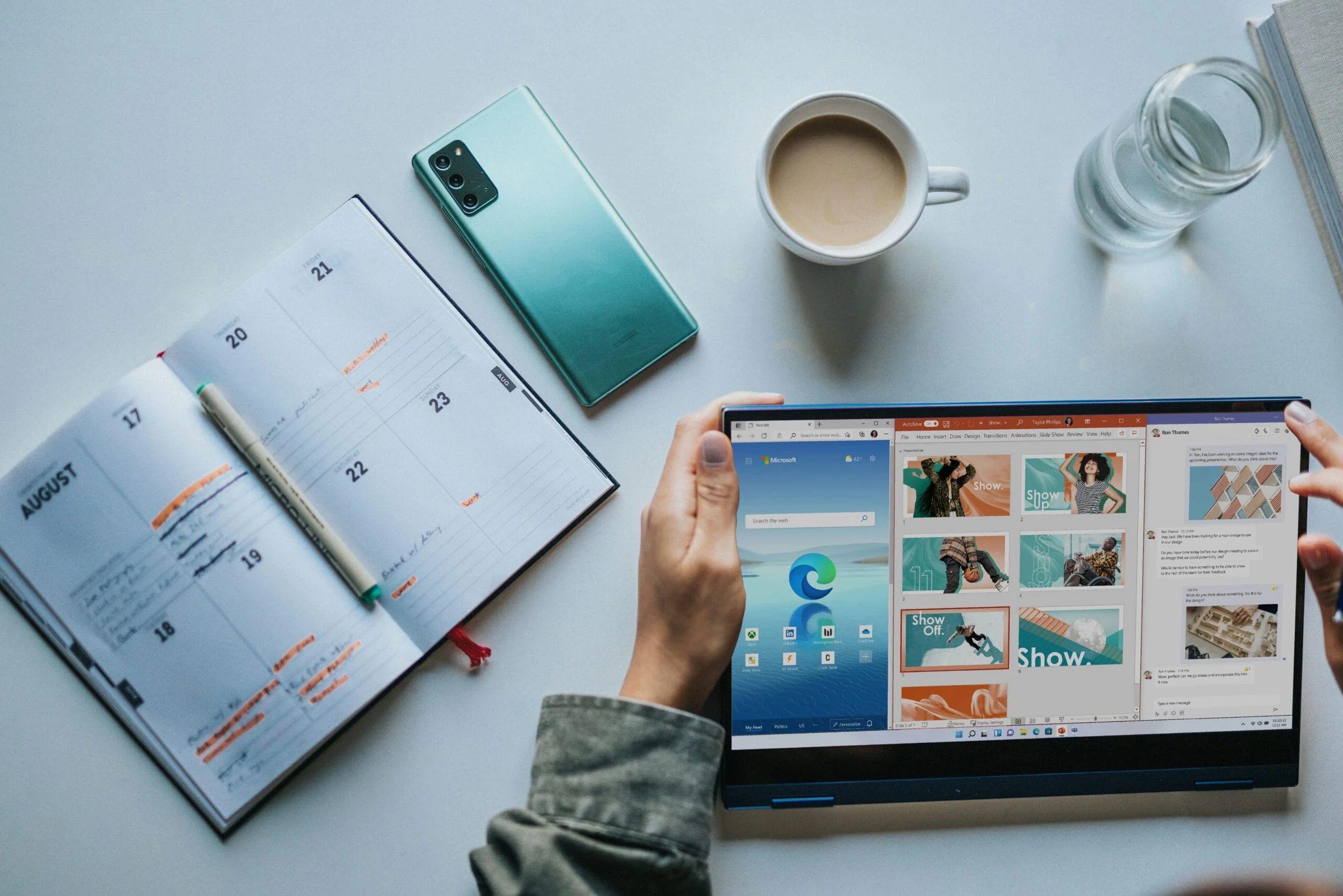 Microsoft 365 tips person using Windows 11 computer beside white ceramic mug on white table