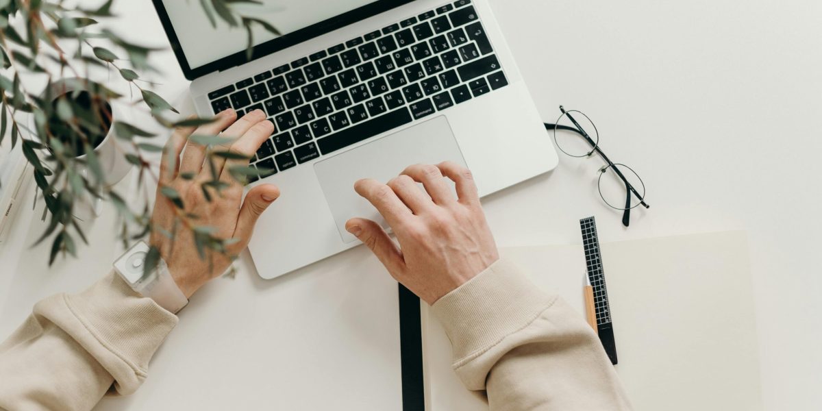 deleted files Free An overhead view of a person working on a laptop in a minimalist home office setting. Stock Photo