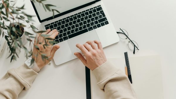 deleted files Free An overhead view of a person working on a laptop in a minimalist home office setting. Stock Photo