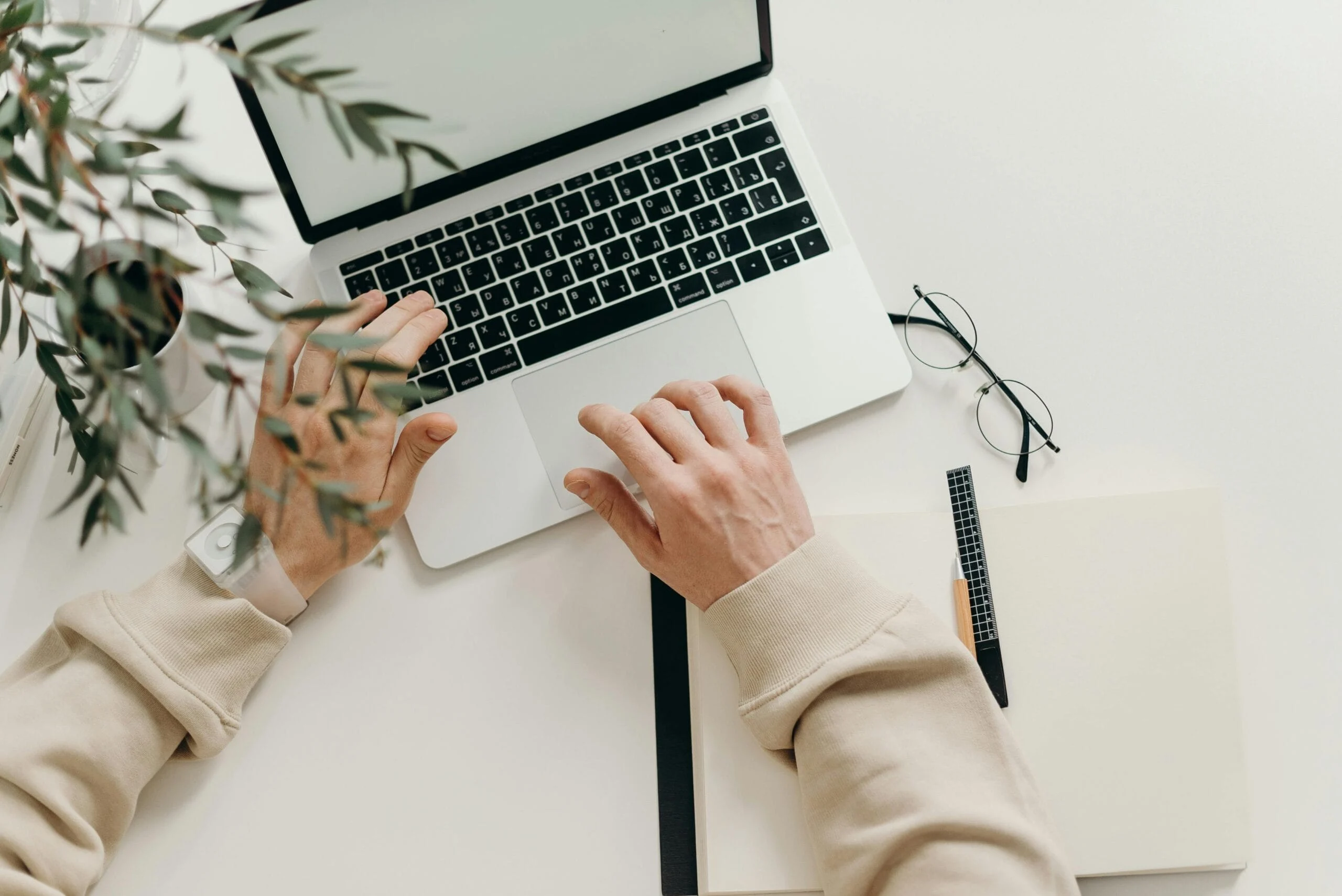 deleted files Free An overhead view of a person working on a laptop in a minimalist home office setting. Stock Photo