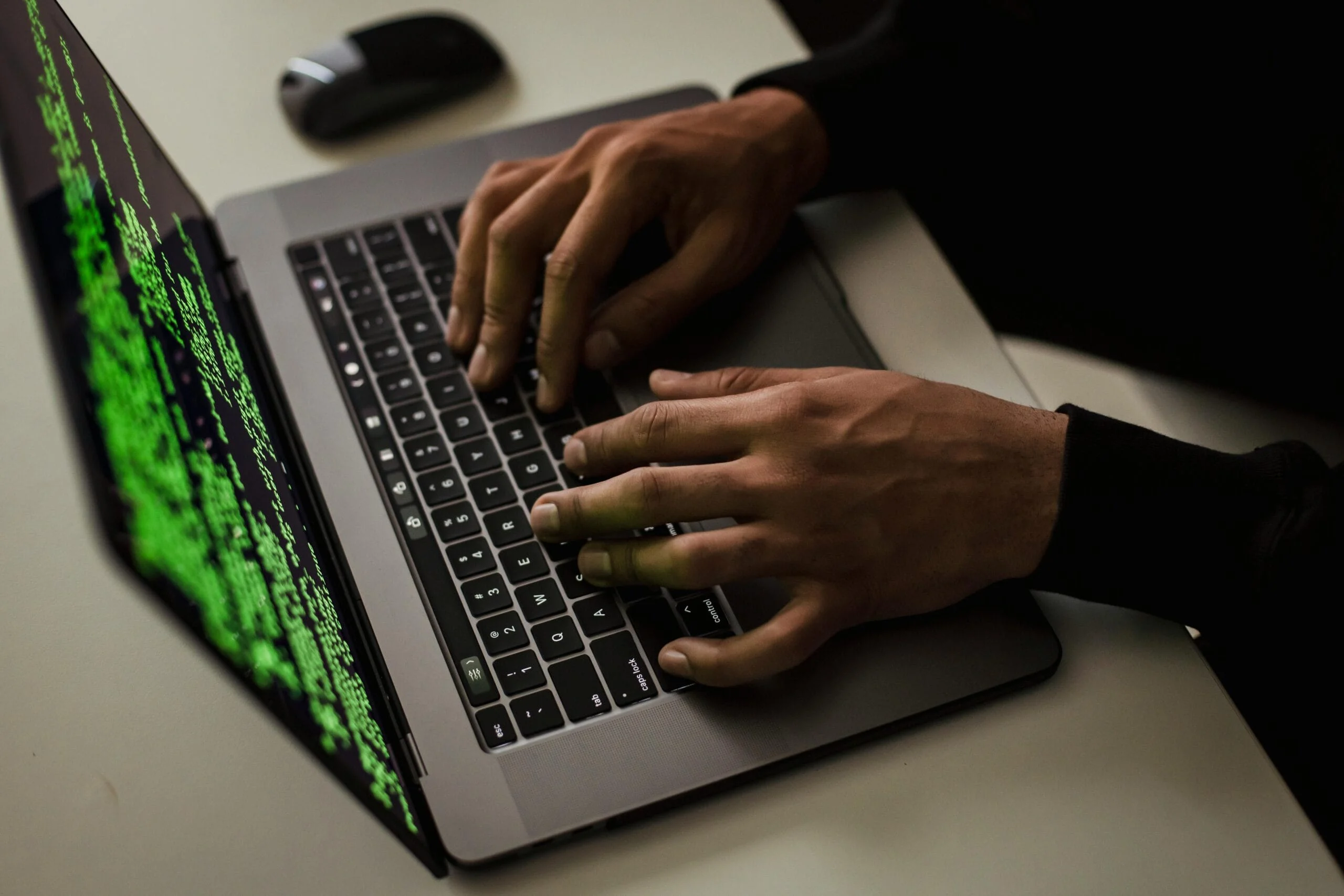 Account security crop-cyber-spy-hacking-system-while-typing-on-laptop