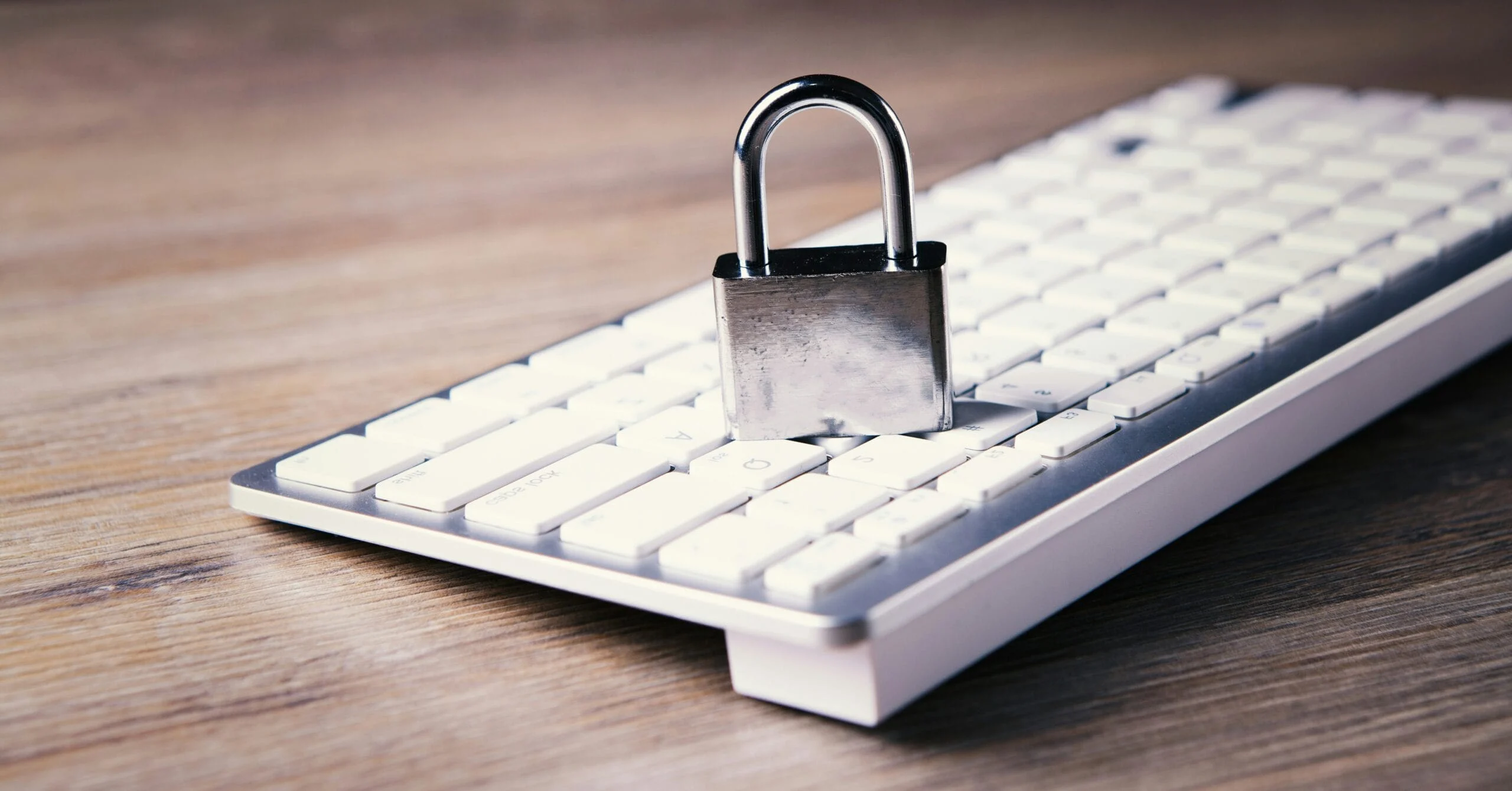 Secure Remote Work a computer keyboard with a padlock on top of it