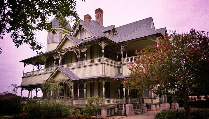 Victorian-style house with colorful flowers