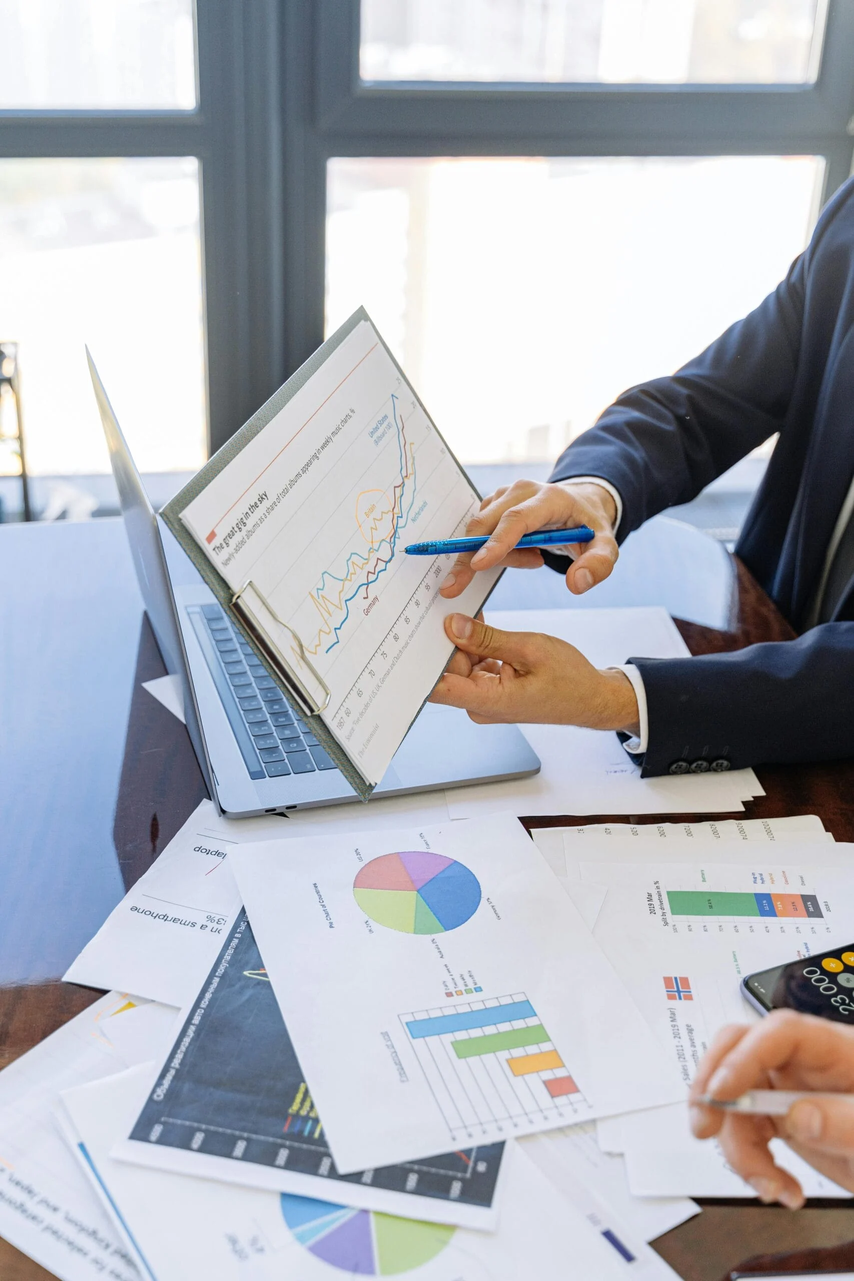 data quality Free Business professionals discussing financial graphs and charts in an office setting. Stock Photo