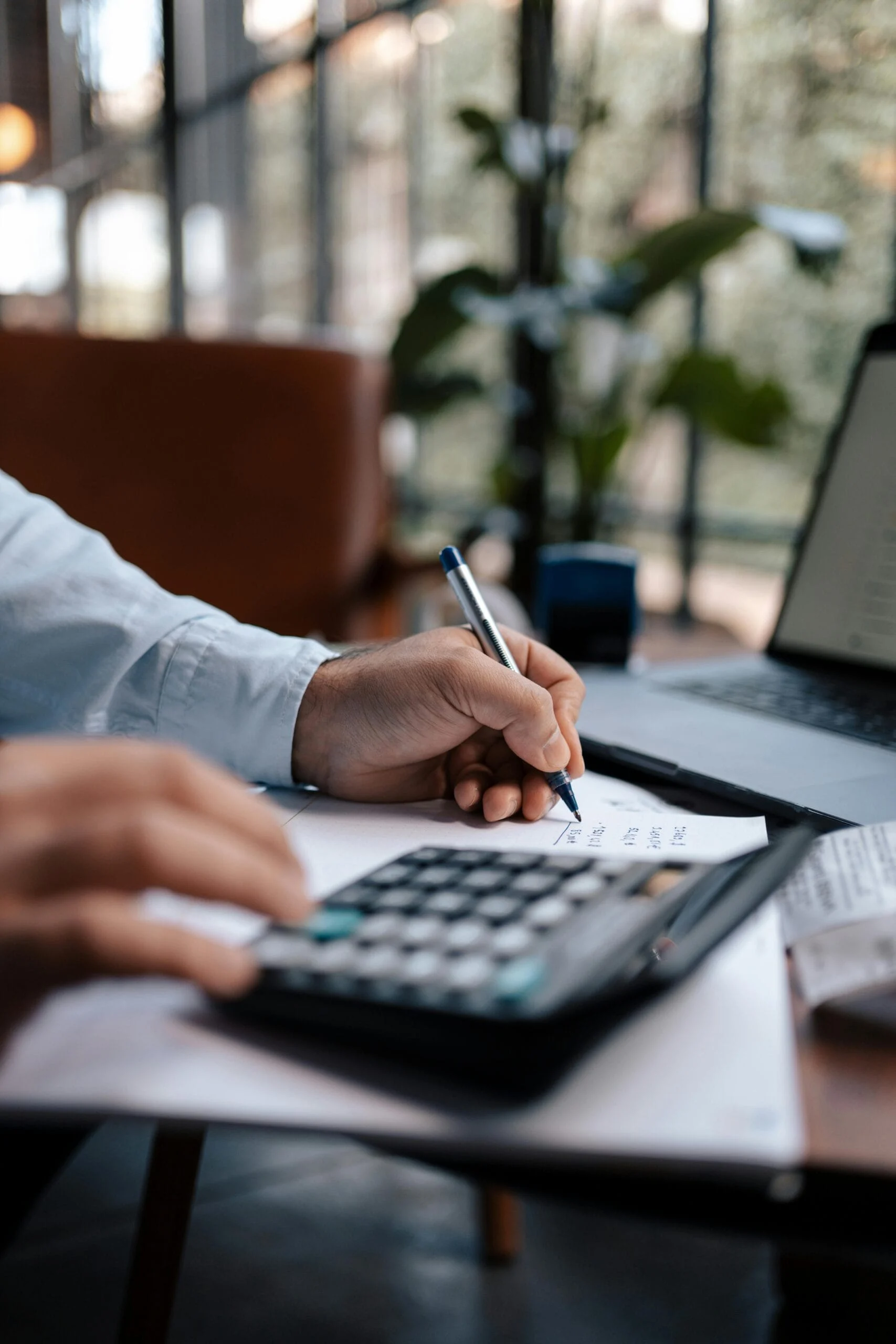 growth tech stack Free A person calculating finances with a calculator and pen on a desk indoors. Stock Photo