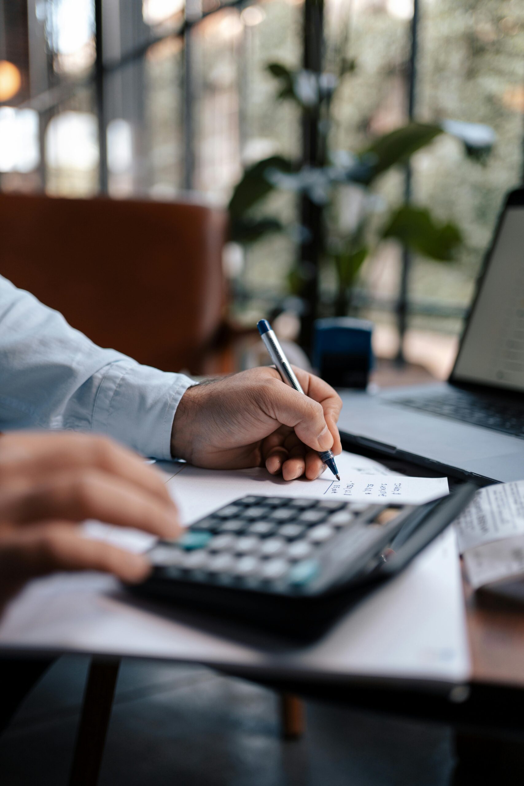 growth tech stack Free A person calculating finances with a calculator and pen on a desk indoors. Stock Photo