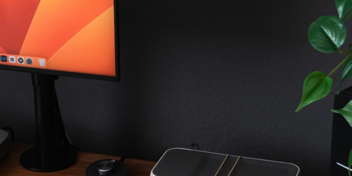 Microsoft Planner a desk with a laptop, keyboard, mouse and a monitor