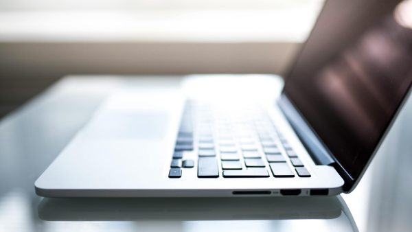 data regulations 2025 Free Elegant side view of a laptop on a glossy table with natural lighting indoors. Stock Photo