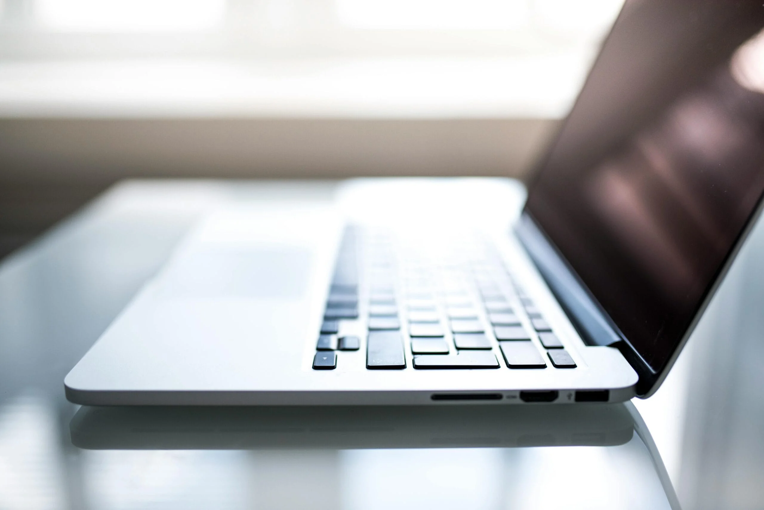 data regulations 2025 Free Elegant side view of a laptop on a glossy table with natural lighting indoors. Stock Photo